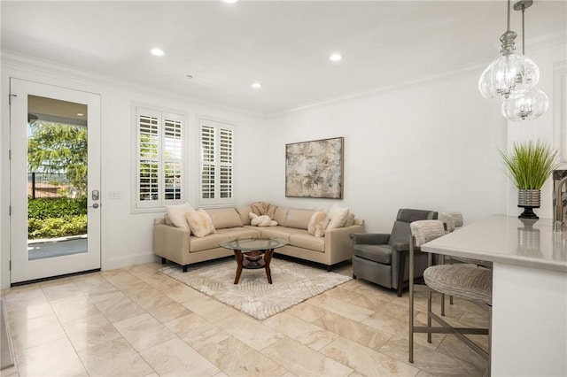 living room with ornamental molding and recessed lighting