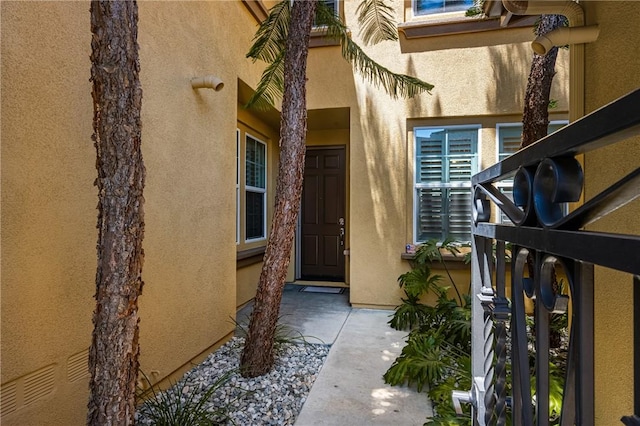 entrance to property featuring stucco siding