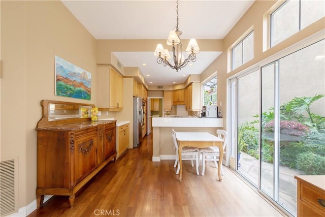 10925 Kimball Pl, Tustin, CA 92782 - dining room with baseboards, an inviting chandelier, light wood finished floors, and visible vents