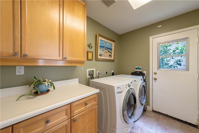 10925 Kimball Pl, Tustin, CA 92782 - laundry area with visible vents, cabinet space, light tile patterned flooring, and washing machine and clothes dryer