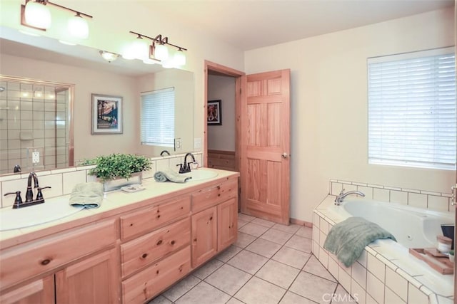 full bath featuring a shower stall, a tub with jets, a sink, and tile patterned flooring
