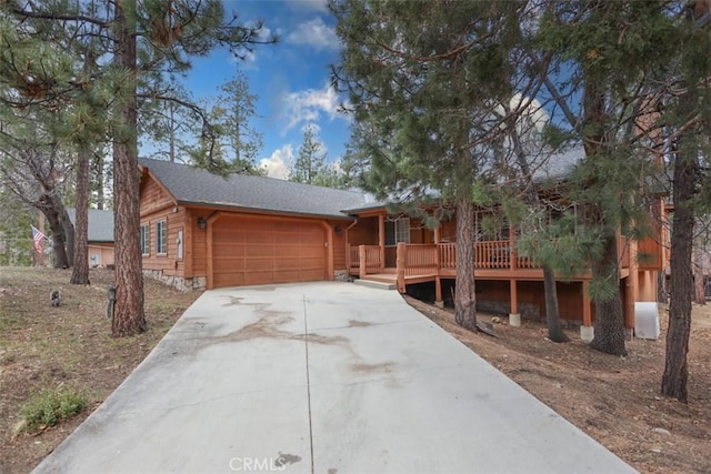 view of front facade featuring a garage, driveway, and covered porch