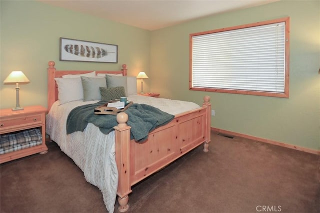 bedroom featuring dark carpet, baseboards, and visible vents