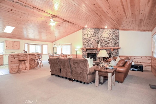 living room with wood ceiling, lofted ceiling, and a fireplace