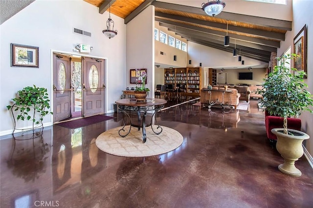 foyer entrance with high vaulted ceiling, visible vents, beam ceiling, and finished concrete flooring
