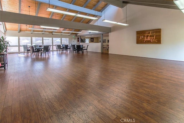 interior space featuring high vaulted ceiling, beam ceiling, and wood finished floors