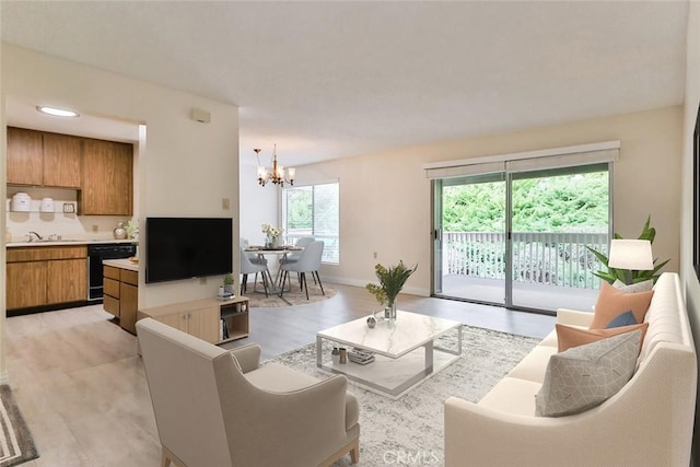 living room featuring baseboards, a notable chandelier, and light wood finished floors