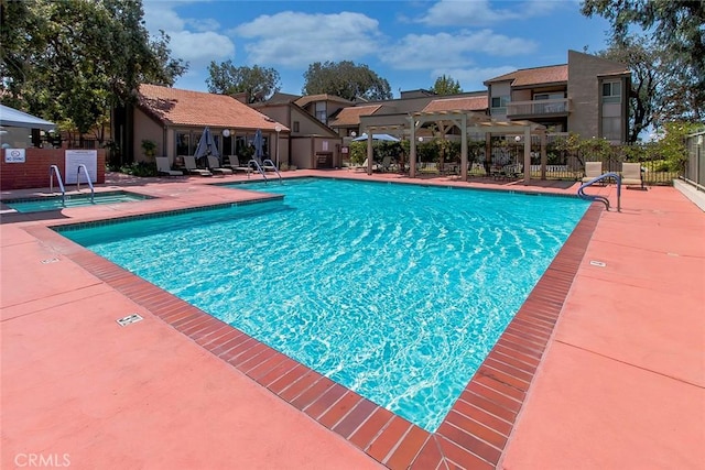 pool with fence and a patio area