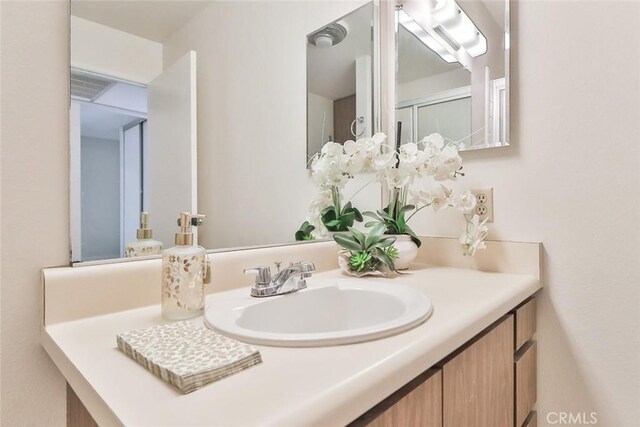 bathroom with vanity and visible vents