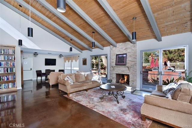 living area with concrete floors, wood ceiling, a wealth of natural light, and a fireplace