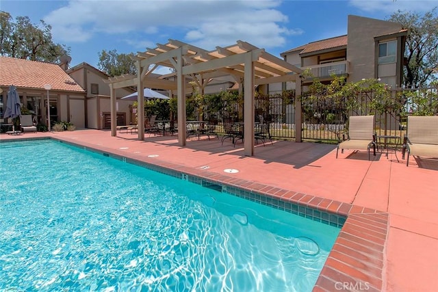 community pool featuring fence, a pergola, and a patio