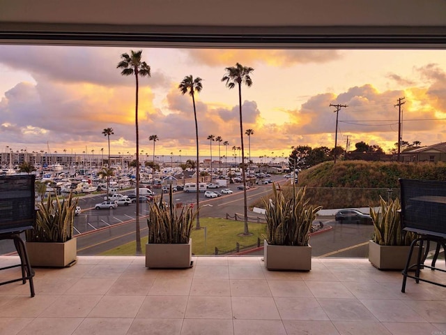 patio terrace at dusk featuring a balcony