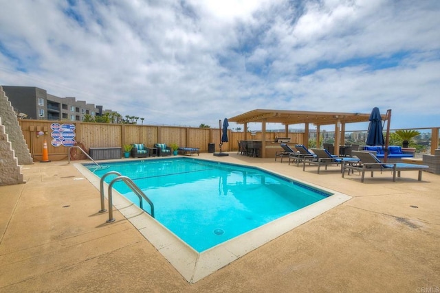 community pool featuring a gazebo, fence, and a patio