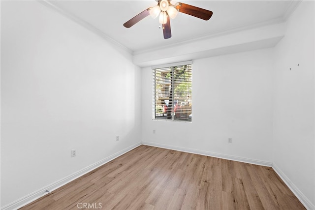 empty room featuring ornamental molding, light wood finished floors, baseboards, and ceiling fan
