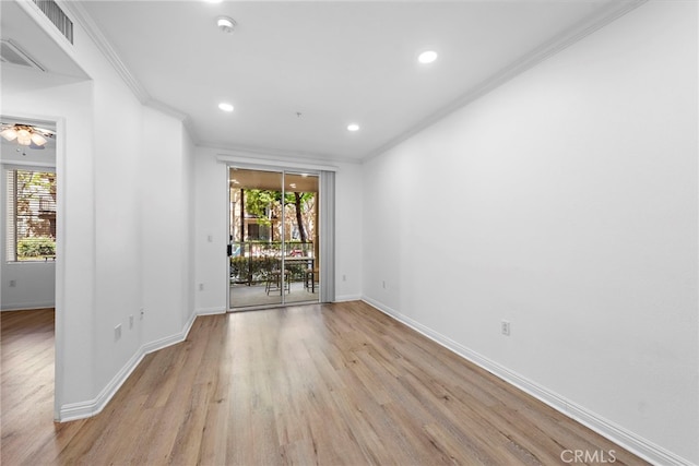 unfurnished room with ornamental molding, plenty of natural light, baseboards, wood finished floors, and recessed lighting