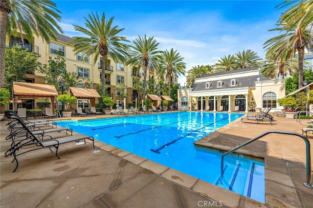 community pool with a patio area