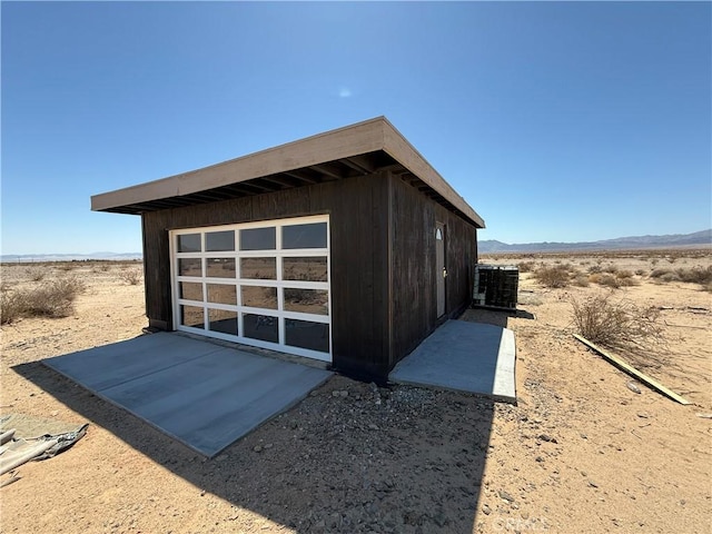 view of outdoor structure featuring a mountain view, an outdoor structure, and central AC unit