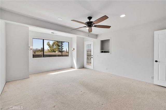 empty room featuring visible vents, a ceiling fan, carpet, and recessed lighting
