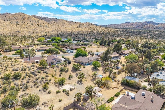 aerial view featuring a residential view, a mountain view, and view of desert