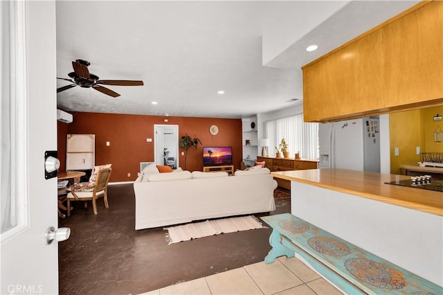 living area featuring recessed lighting, a ceiling fan, and baseboards