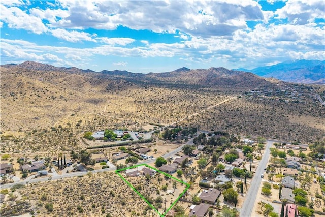 drone / aerial view featuring a mountain view and a desert view