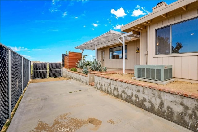 view of patio featuring a fenced backyard, central AC unit, and a pergola