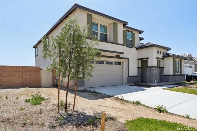 687 Ballesteros St, Perris, CA 92571 - view of front of property with concrete driveway, an attached garage, fence, and stucco siding