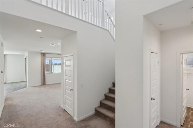 687 Ballesteros St, Perris, CA 92571 - stairway with baseboards, a high ceiling, carpet, and recessed lighting