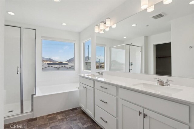 687 Ballesteros St, Perris, CA 92571 - full bathroom featuring visible vents, a shower stall, a sink, and a bath