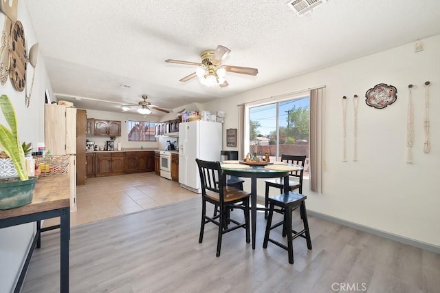 1107 B St, Brawley, CA 92227 - dining space featuring visible vents, a textured ceiling, ceiling fan, and light wood finished floors