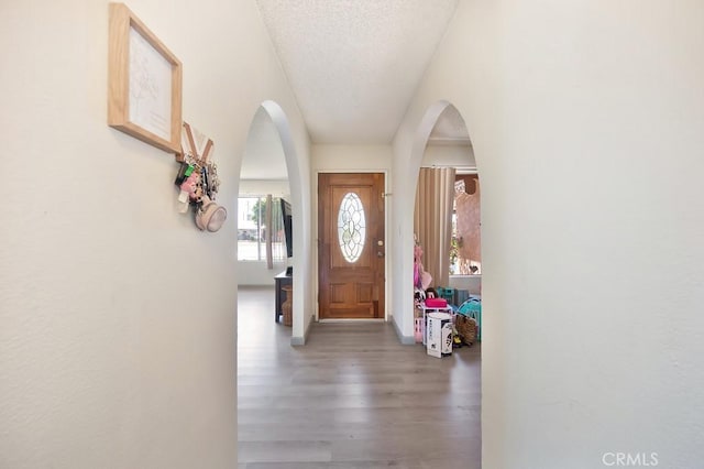 1107 B St, Brawley, CA 92227 - entryway with baseboards, arched walkways, a textured ceiling, and wood finished floors