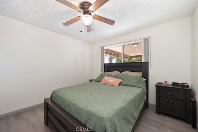 1107 B St, Brawley, CA 92227 - bedroom with baseboards, a textured ceiling, light wood finished floors, and ceiling fan
