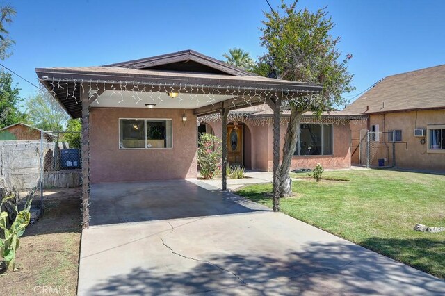 1107 B St, Brawley, CA 92227 - view of front of property with fence, stucco siding, and a front yard