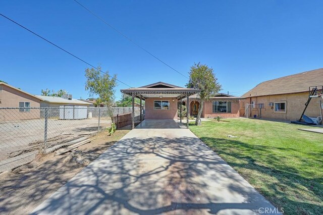 1107 B St, Brawley, CA 92227 - single story home with fence, a front yard, stucco siding, driveway, and a carport