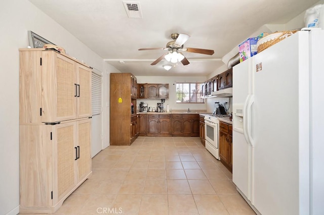 1107 B St, Brawley, CA 92227 - kitchen featuring white appliances, light countertops, a ceiling fan, light tile patterned floors, and visible vents