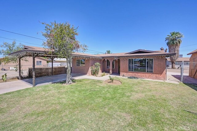 1107 B St, Brawley, CA 92227 - ranch-style house featuring a front lawn, fence, stucco siding, a gazebo, and a carport
