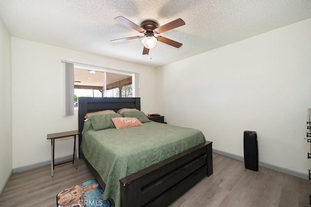 1107 B St, Brawley, CA 92227 - bedroom featuring baseboards, a textured ceiling, ceiling fan, and light wood-style floors