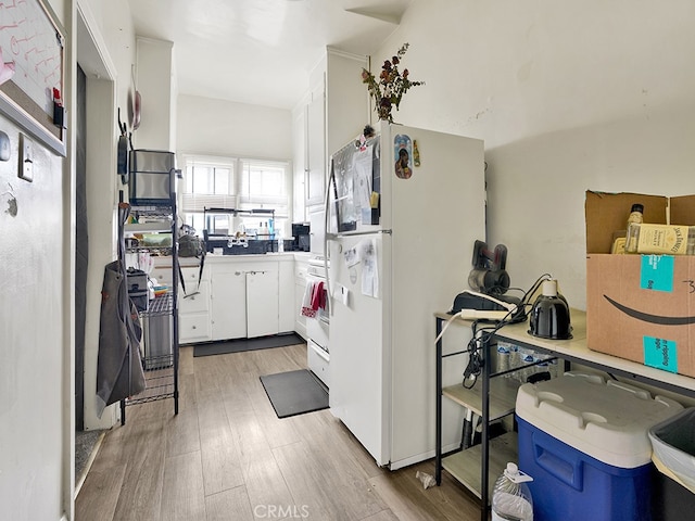 1407 Obispo Ave, Long Beach, CA 90804 - kitchen with freestanding refrigerator, white cabinets, light wood-style floors, and light countertops