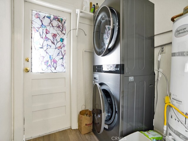 1407 Obispo Ave, Long Beach, CA 90804 - clothes washing area featuring stacked washer and clothes dryer, water heater, and wood finished floors