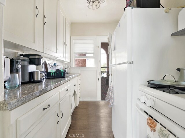 1407 Obispo Ave, Long Beach, CA 90804 - kitchen with dark wood-type flooring, white cabinetry, white gas range oven, and dark stone countertops
