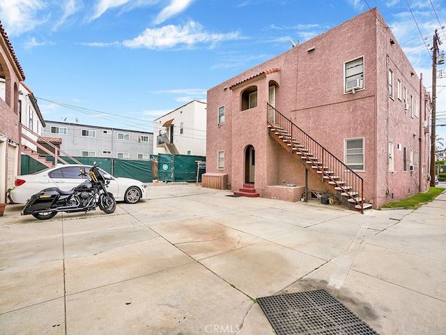 1407 Obispo Ave, Long Beach, CA 90804 - view of vehicle parking with stairs, fence, and a residential view
