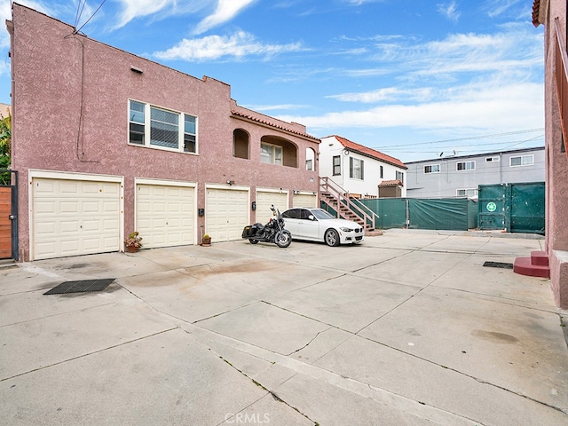 1407 Obispo Ave, Long Beach, CA 90804 - view of front of house featuring stucco siding, fence, and driveway