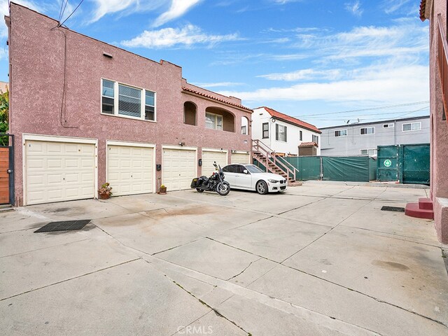 1407 Obispo Ave, Long Beach, CA 90804 - view of front of house featuring stucco siding, fence, and driveway