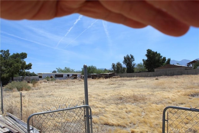 view of yard featuring fence and a rural view