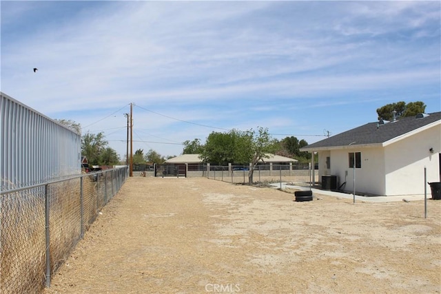 view of yard with fence and central AC