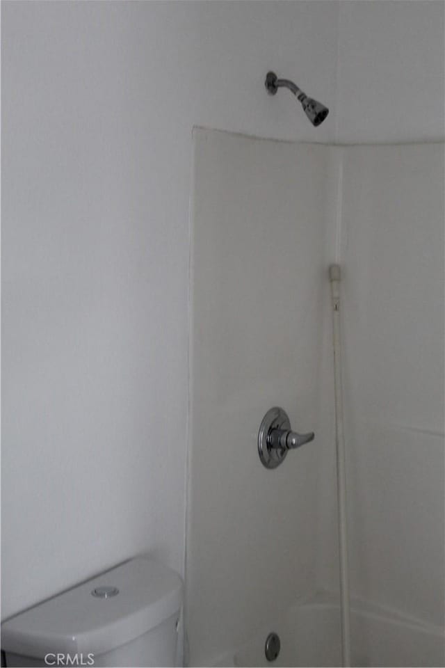 full bath featuring toilet and a shower