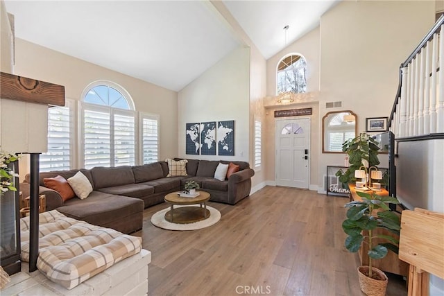 11691 Mount Baker Ct, Rancho Cucamonga, CA 91737 - living area with high vaulted ceiling, hardwood / wood-style flooring, healthy amount of natural light, and baseboards