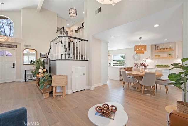 11691 Mount Baker Ct, Rancho Cucamonga, CA 91737 - entrance foyer featuring a high ceiling, stairway, light wood finished floors, beamed ceiling, and baseboards
