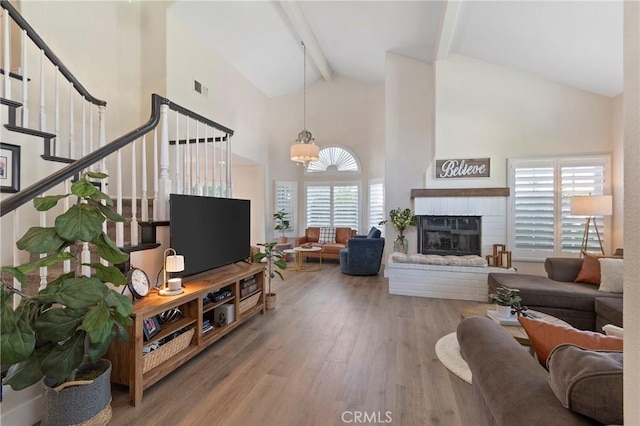 11691 Mount Baker Ct, Rancho Cucamonga, CA 91737 - living area with high vaulted ceiling, wood finished floors, beamed ceiling, healthy amount of natural light, and stairway