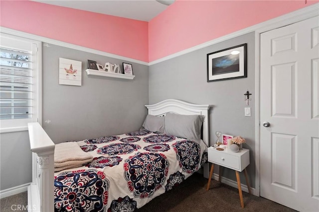 bedroom featuring carpet floors and baseboards
